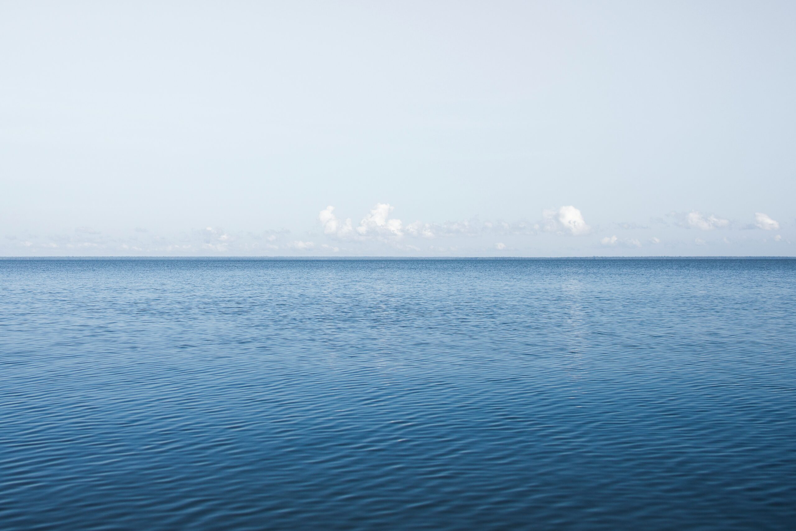 blue sea under blue sky during daytime